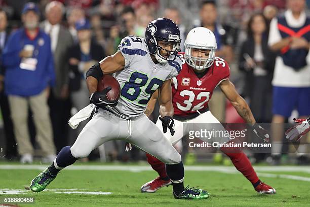 Wide receiver Doug Baldwin of the Seattle Seahawks runs with the football after a reception ahead of free safety Tyrann Mathieu of the Arizona...
