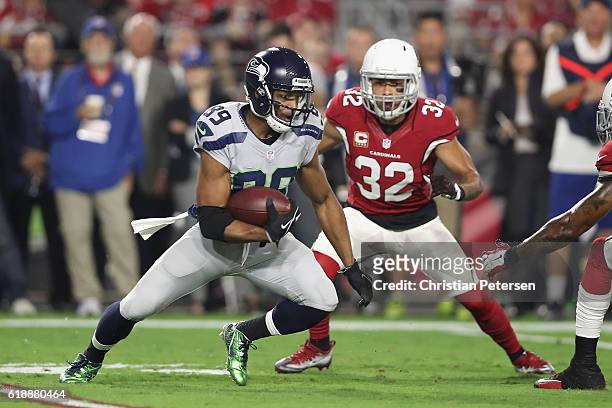 Wide receiver Doug Baldwin of the Seattle Seahawks runs with the football after a reception ahead of free safety Tyrann Mathieu of the Arizona...