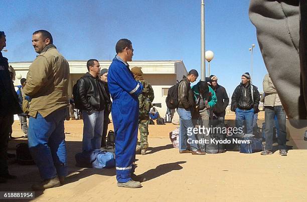 Algeria - Photo taken secretly on Jan. 16 by one of the Algerians held hostage at a gas plant in In Amenas shows Algerian workers standing outside an...