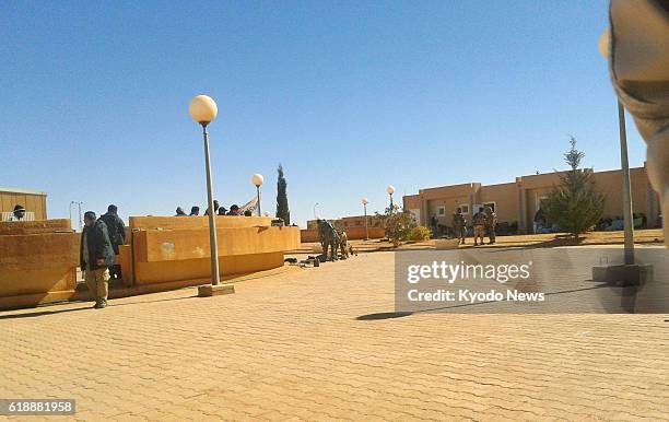 Algeria - Photo taken secretly on Jan. 16 by one of the Algerians held hostage at a gas plant in In Amenas shows three attackers guarding foreigners...