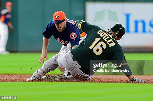 Houston Astros infielder Danny Worth tags Oakland Athletics First base Billy Butler out at second during the Athletics at Astros baseball game at...