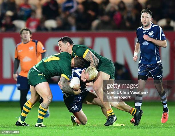 Scotland's Lewis Tierney is tackled by Australia's Jake Friend, left, and Australia's Tyson Frizellduring the Four Nations match between the...