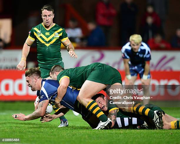 Scotland's Ben Hellewell is tackled by Australia's Trent Merrin and Jake Friend during the Four Nations match between the Australian Kangaroos and...