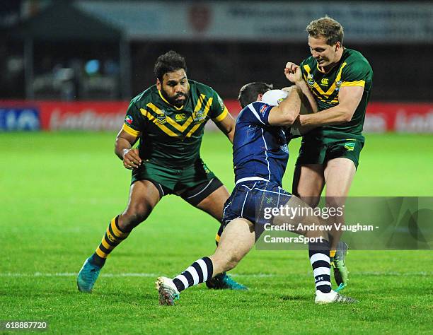 Scotland's Danny Brough is tackled by Australia's Sam Thaiday and Australia's Jake Trbojevic during the Four Nations match between the Australian...