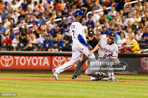 Washington Nationals first baseman Daniel Murphy holds New York Mets shortstop Jose Reyes to first base during a National League East match-up...