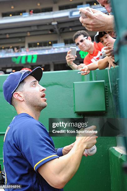 Milwaukee Brewers left fielder Ryan Braun signs an autograph for a fan at Nationals Park in Washington, D.C. Where the Washington Nationals defeated...