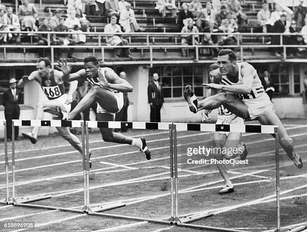 View of the 4th heat of the 110-meter hurdles event of the Men's Decathlon in Helsinki Olympic Stadium during the Games of the XV Olympiad, Helsinki,...