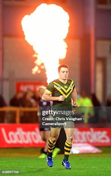 Australia's Cooper Cronk runs past a pyrotechnic flame thrower as he returns to the field for the second halfduring the Four Nations match between...