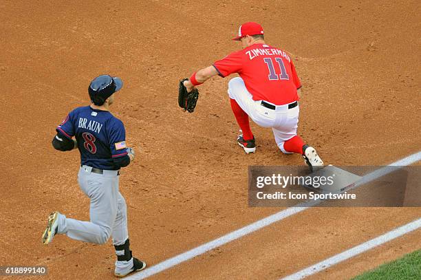 Washington Nationals first baseman Ryan Zimmerman reaches to catch a throw to retire Milwaukee Brewers left fielder Ryan Braun at Nationals Park in...