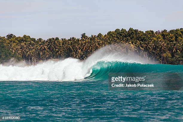 huge surfing wave breaking in the mentawai islands - indonesia sumatra mentawai stock pictures, royalty-free photos & images