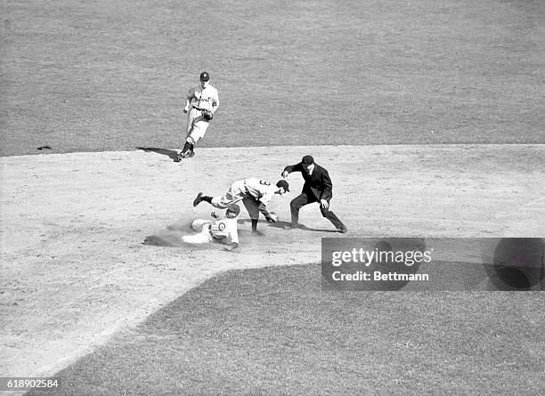 Hack of Cubs slides into second where he was tagged out after attempting a free base during the third inning of the fifth World Series game today...