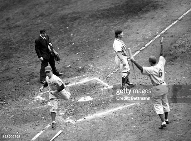 Andy Pafko of the Chicago Cubs is shown crossing the plate to score the second run for his side in the fourth inning of the third world series game...