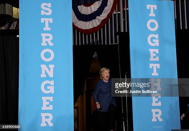 Democratic presidential nominee former Secretary of State Hillary Clinton greets supporters during a campaign rally at Roosevelt High School on...
