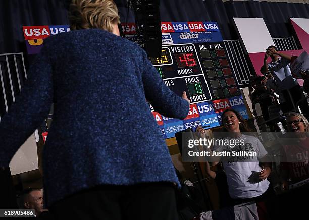 Democratic presidential nominee former Secretary of State Hillary Clinton greets supporters during a campaign rally at Roosevelt High School on...