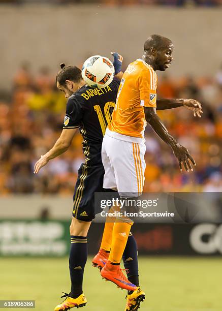 Philadelphia Union midfielder Tranquillo Barnetta and Houston Dynamo midfielder DaMarcus Beasley go up for a header during the MLS soccer match...