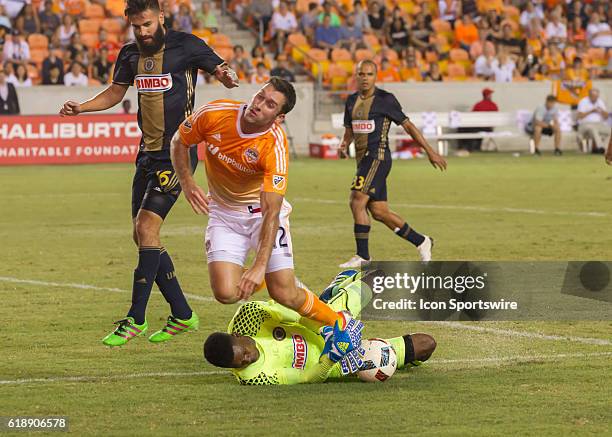 Houston Dynamo defender Will Bruin runs over Philadelphia Union goalkeeper Andre Blake during the MLS soccer match between Philadelphia Union and...