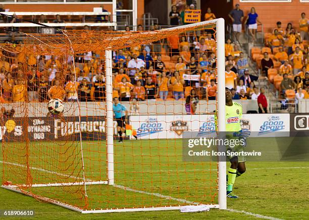 Philadelphia Union goalkeeper Andre Blake is dejected after falling to stop the goal scored on a free kick by Houston Dynamo midfielder Cristian...