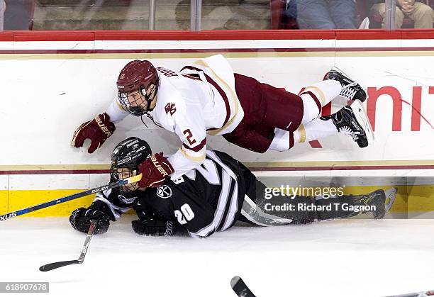 Mike Booth of the Boston College Eagles dives over Kasper Bjorkqvist of the Providence College Friars during NCAA hockey at Kelley Rink on October...