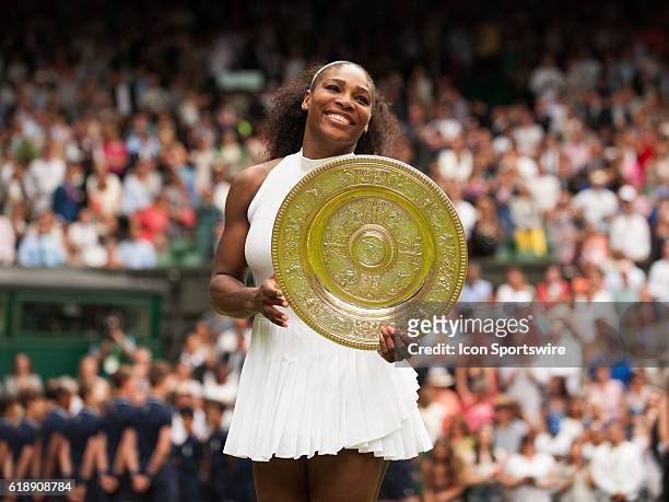 Serena Williams poses with the trophy after winning the women's singles title during The Championships, Wimbledon, at the All England Lawn Tennis and...