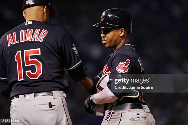 Jose Ramirez of the Cleveland Indians is congratulated by first base coach Sandy Alomar Jr. After hitting a single in the fourth inning against the...