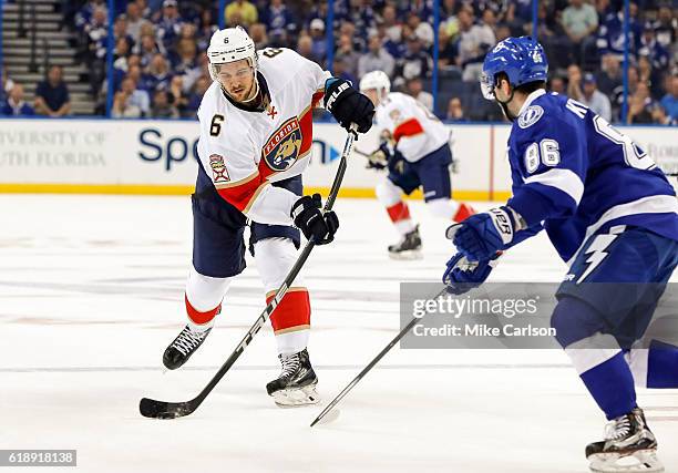 Alex Petrovic of the Florida Panthers shoots past Nikita Kucherov of the Tampa Bay Lightning during the third period at the Amalie Arena on October...