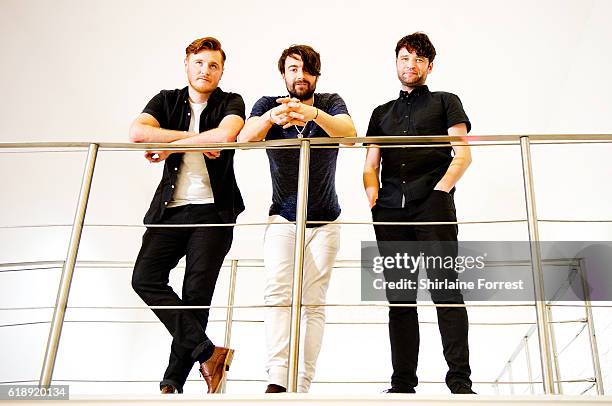 Daniel Moores, Liam Fray and Michael Campbell of The Courteeners pose backstage after performing a live set and signing copies of their new album...