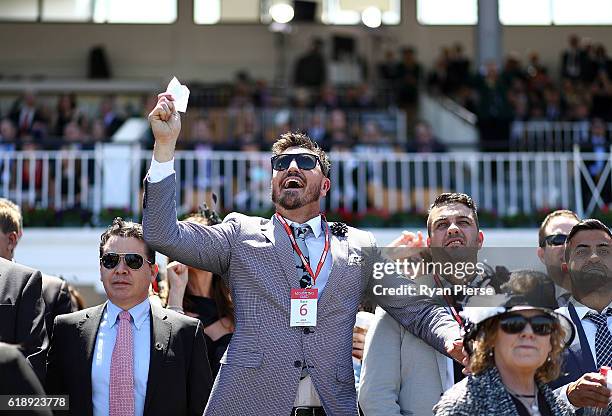 Crowd cheer on Victoria Derby Day at Flemington Racecourse on October 29, 2016 in Melbourne, Australia.