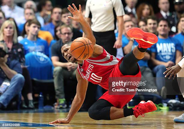 Eric Gordon of the Houston Rockets gets tripped up against the Dallas Mavericks in the second half at American Airlines Center on October 28, 2016 in...