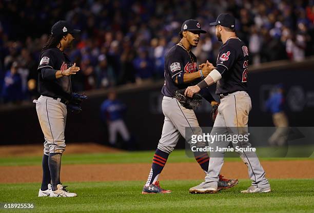 Michael Martinez, Francisco Lindor and Jason Kipnis of the Cleveland Indians celebrate after beating the Chicago Cubs 1-0 in Game Three of the 2016...