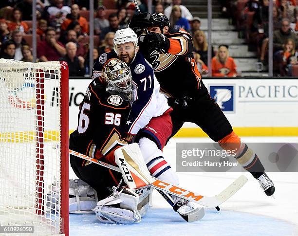 Nick Foligno of the Columbus Blue Jackets collides with John Gibson of the Anaheim Ducks as Kevin Bieksa of the Anaheim Ducks follows during the...