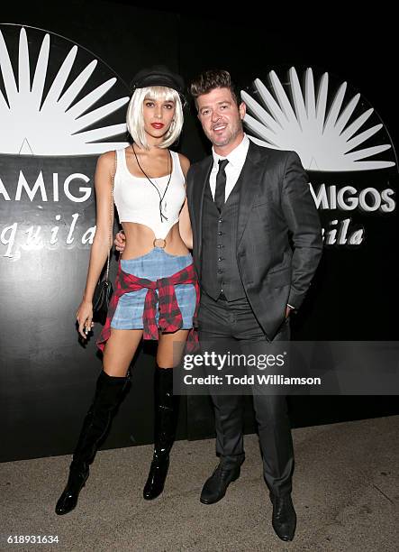 Singer Robin Thicke and guest arrive to the Casamigos Halloween Party at a private residence on October 28, 2016 in Beverly Hills, California.