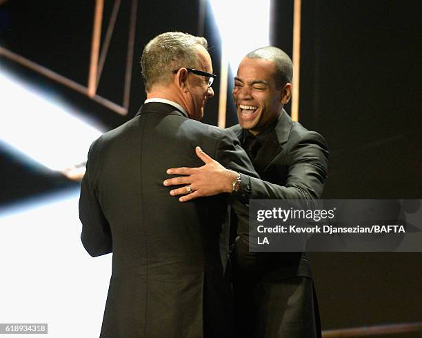 Presenter Tom Hanks and Host Ben "Doc Brown" Smith onstage at the 2016 AMD British Academy Britannia Awards presented by Jaguar Land Rover and...