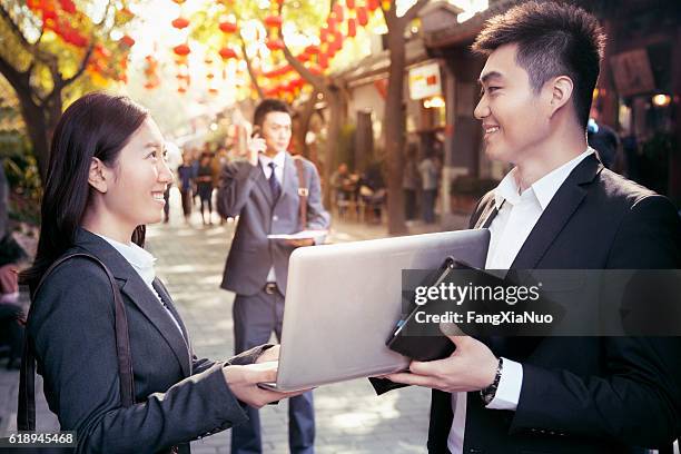 business people meeting in pedestrian street - china red stock pictures, royalty-free photos & images