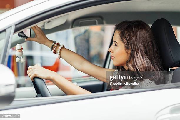 adjusting rearview mirror - mirrors while driving stock pictures, royalty-free photos & images