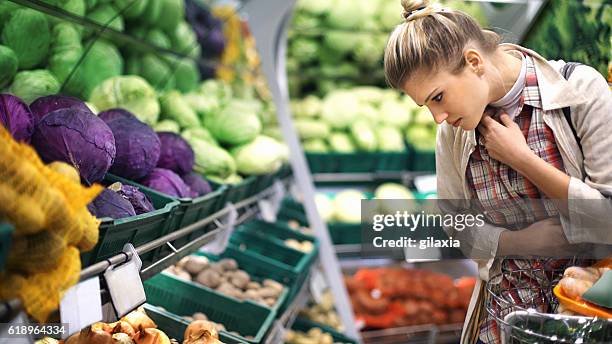 woman buying vegetables at a supermarket. - greengrocer stock pictures, royalty-free photos & images