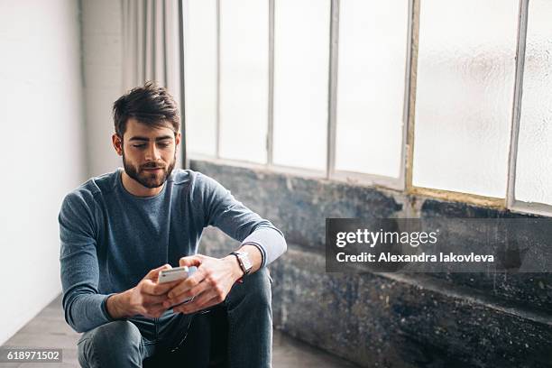 young man chatting on the phone - modern boy hipster stock pictures, royalty-free photos & images