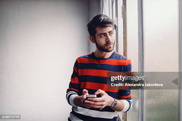 young man chatting on the phone - modern boy hipster stock pictures, royalty-free photos & images