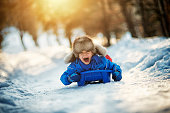 Little boy having extreme fun on his sled