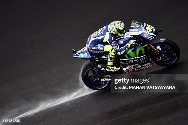 Movistar Yamaha MotoGP's Italian rider Valentino Rossi powers his bike during the qualifying session of the 2016 Malaysian MotoGP at the Sepang...