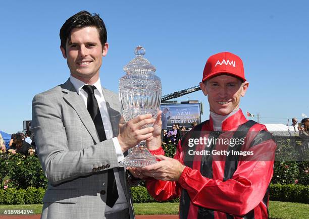 Trainer James Cummings and Glyn Schofield pose with trophy after Prized Icon won Race 7, AAMi Victoria Derby on Derby Day at Flemington Racecourse on...