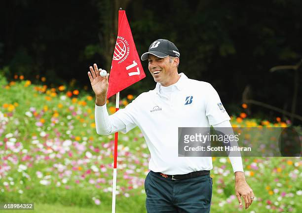 Matt Kuchar of the Unites States waves to the gallery after a hole-in-one on the 17th hole during the third round of the WGC - HSBC Champions at the...