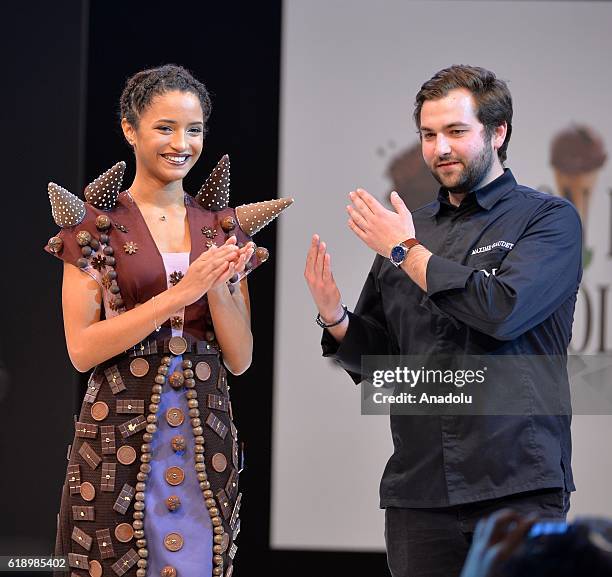 Model with a chocolate dress and a designer are seen onstage during the 22nd edition of Salon du Chocolat , the world's largest event dedicated to...