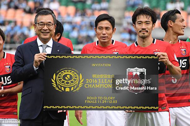 Mitsuru Murai and Captain Yuki Abe of Urawa Red Diamonds hold a invitation of championship after winning the J.League second stage after the J.League...