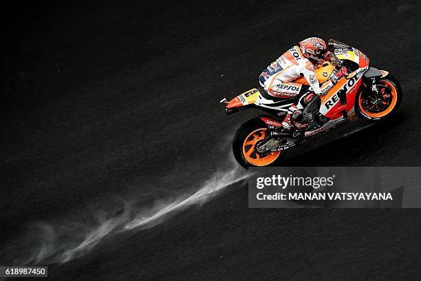 Repsol Honda Team's Spanish rider Marc Marquez powers his bike during the qualifying session of the 2016 Malaysian MotoGP at the Sepang International...