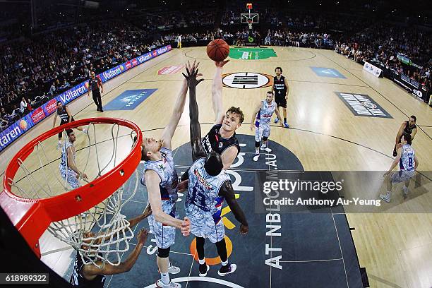 Finn Delany of New Zealand puts up a shot against Majok Deng and Matt Hodgson of Adelaide during the round four NBL match between the New Zealand...