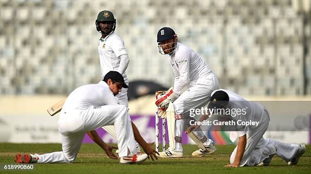 Imrul Kayes of Bangladesh plays the ball between England captain Alastair Cook, Joe Root and Jonathan Bairstow during the second day of the 2nd Test...
