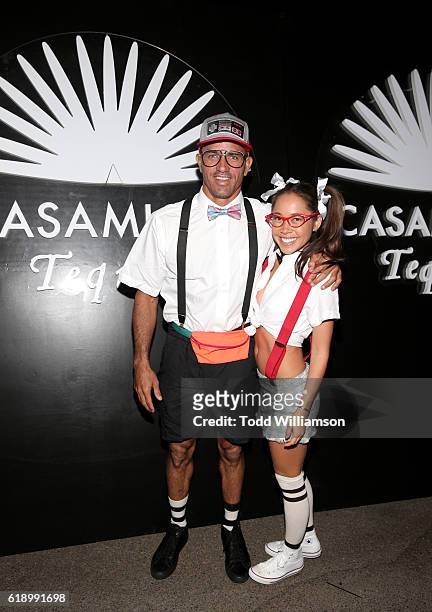 Surfer Kelly Slater and guest arrive to the Casamigos Halloween Party at a private residence on October 28, 2016 in Beverly Hills, California.