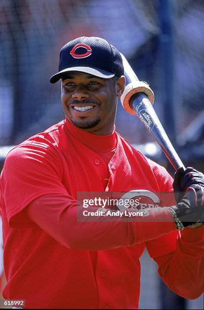 Ken Griffey Jr. #30 of the Cincinnati Reds smiles as he practices his batting before the Spring Training game against the Cleveland Indians at the...