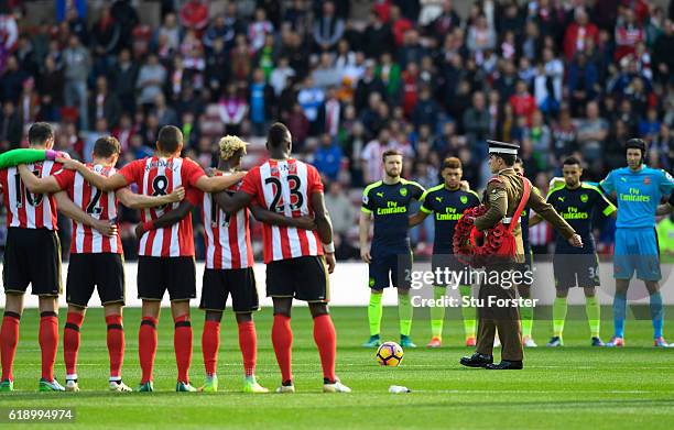 Players observe a minute of silence ahead of the Remeberance day prior to the Premier League match between Sunderland and Arsenal at the Stadium of...