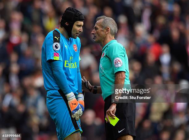 Referee Martin Atkinson talks to Petr Cech of Arsenal before showing an yellow card during the Premier League match between Sunderland and Arsenal at...
